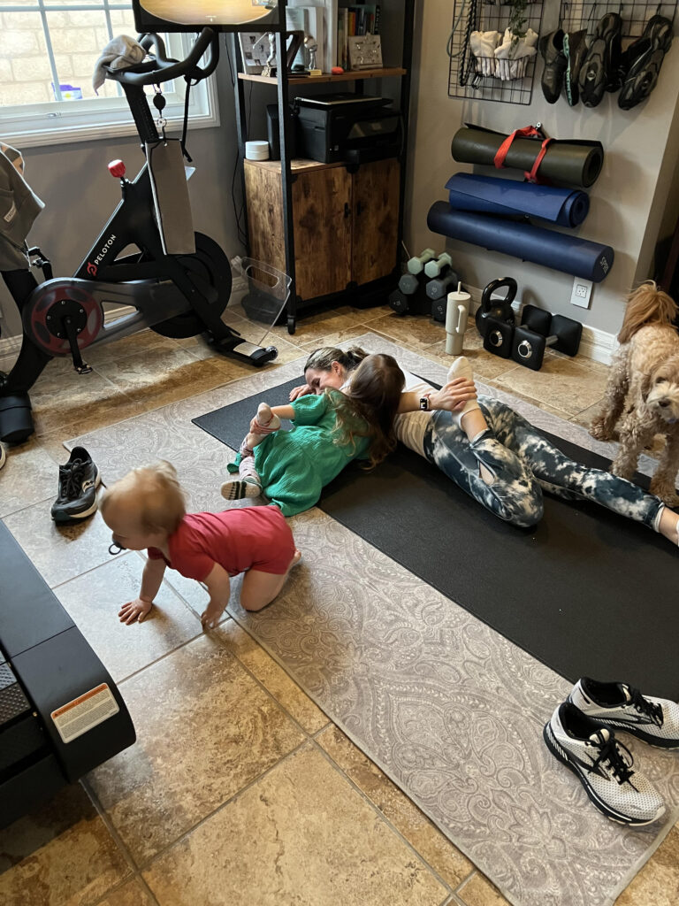 Busy mom doing low-impact workout at home with kids as part of stress management for clear skin routine