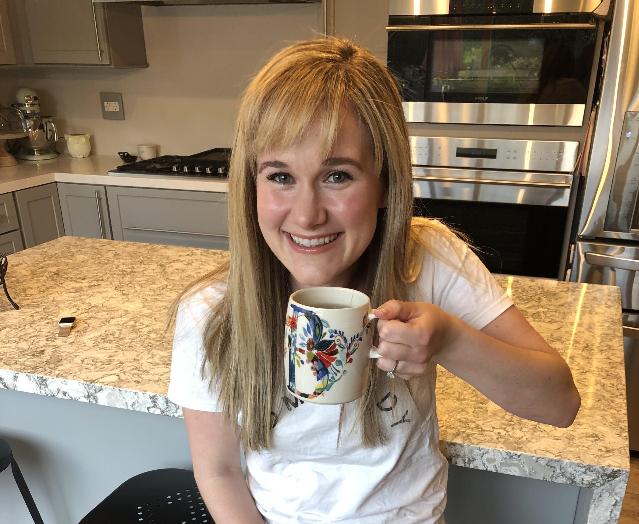 Brittany Clapp, founder of Toxin Free Clear Skin, holding a warm mug of her daily dandy latte — a coffee alternative made with dandelion root and mushroom powder to support clear skin and hormone balance